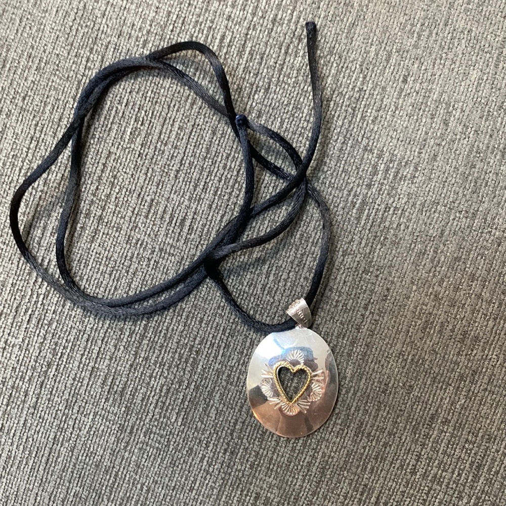 Sterling silver heard necklace with a black silk cord (adjustable tie cord).